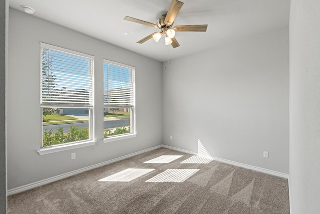 spare room with carpet floors and ceiling fan