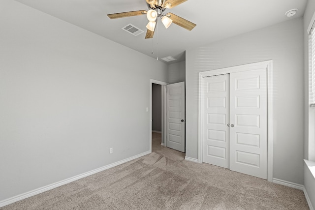 unfurnished bedroom with carpet floors, a closet, and ceiling fan