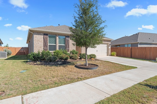 view of front of property featuring a front yard, a garage, and central air condition unit