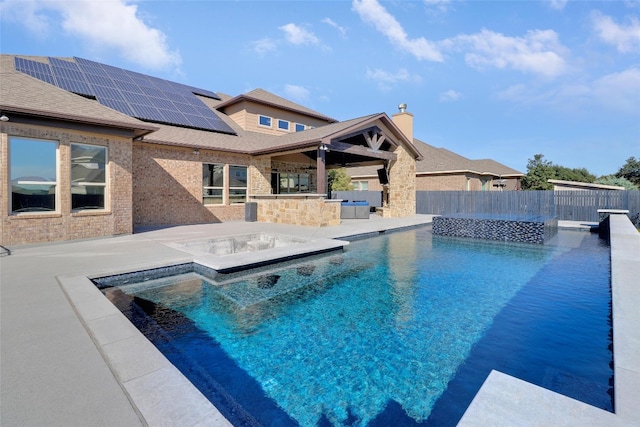 view of swimming pool featuring a patio and a hot tub