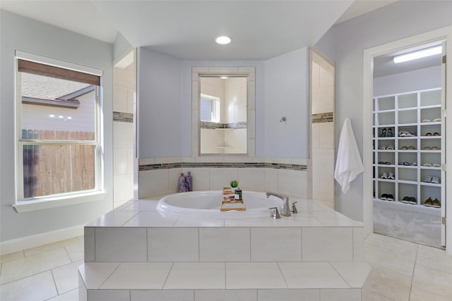 bathroom featuring tile patterned floors and tiled tub