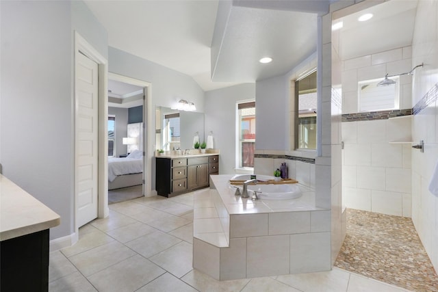 bathroom with vanity, tile patterned flooring, and plus walk in shower