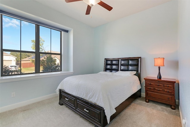 bedroom featuring light colored carpet and ceiling fan