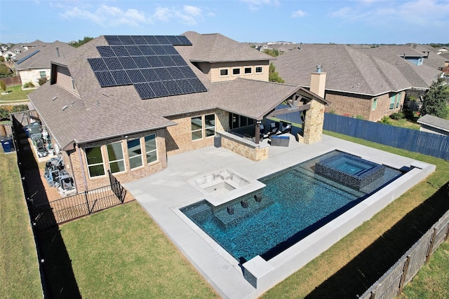 view of swimming pool featuring an in ground hot tub and a patio area