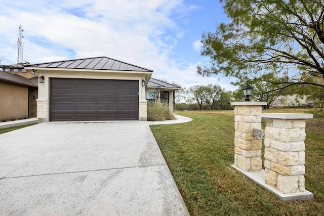 view of front of house with a garage and a front lawn