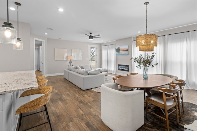 dining area featuring ceiling fan and dark wood-type flooring