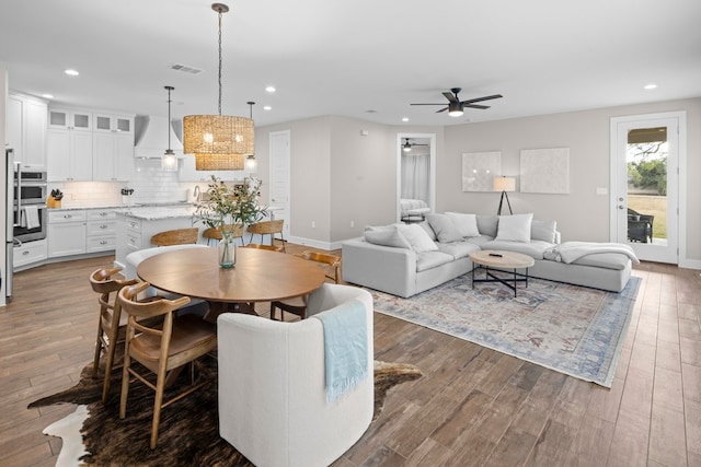 living room featuring dark hardwood / wood-style floors and ceiling fan