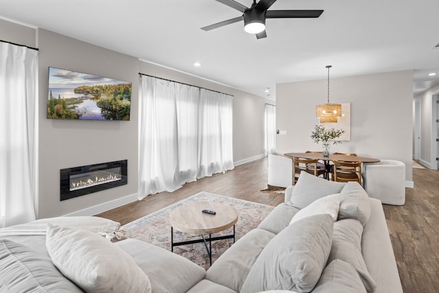 living room with hardwood / wood-style floors and ceiling fan