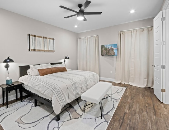 bedroom featuring ceiling fan and dark wood-type flooring