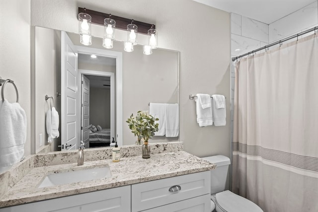 bathroom featuring vanity, curtained shower, and toilet