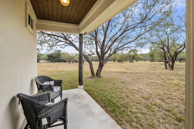 view of yard featuring a rural view and a patio