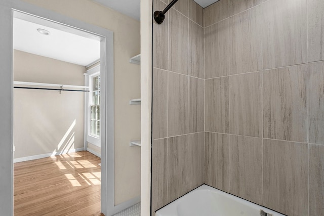 bathroom featuring shower / bathing tub combination and hardwood / wood-style floors