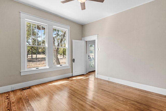 spare room featuring light wood-type flooring and ceiling fan