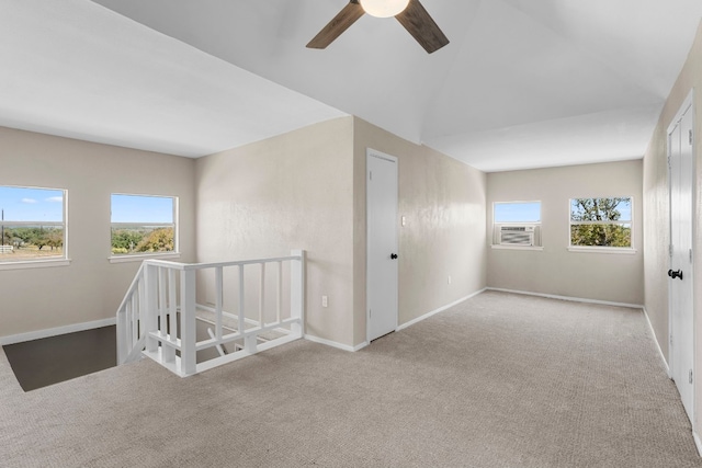 bonus room with ceiling fan and light colored carpet