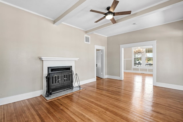 unfurnished living room featuring ceiling fan with notable chandelier, hardwood / wood-style flooring, and beam ceiling