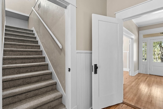 staircase with hardwood / wood-style floors