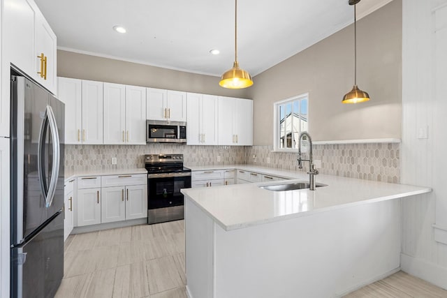 kitchen with kitchen peninsula, stainless steel appliances, white cabinets, and sink