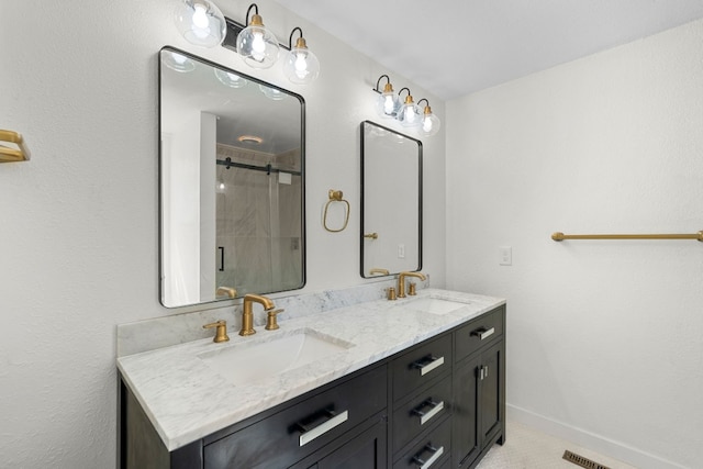 bathroom with vanity and a shower with shower door