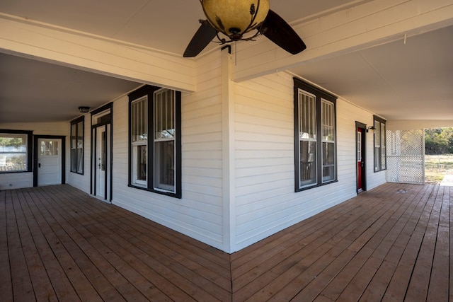 wooden terrace featuring ceiling fan and a porch