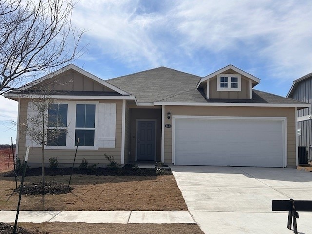 single story home featuring board and batten siding, concrete driveway, and a garage