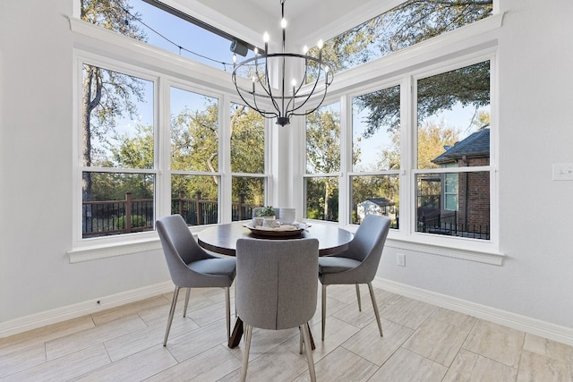 sunroom / solarium featuring a notable chandelier