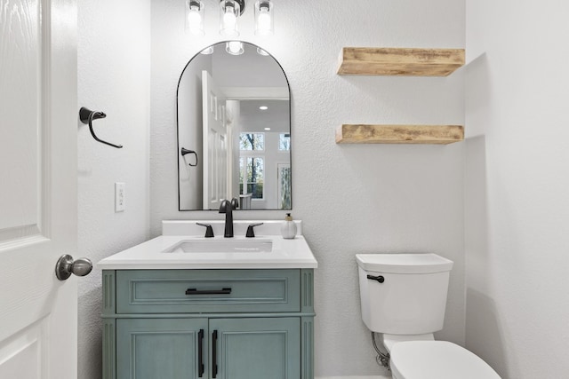 bathroom featuring vanity and toilet