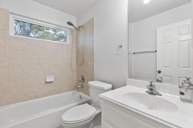 full bathroom with tiled shower / bath combo, toilet, and vanity