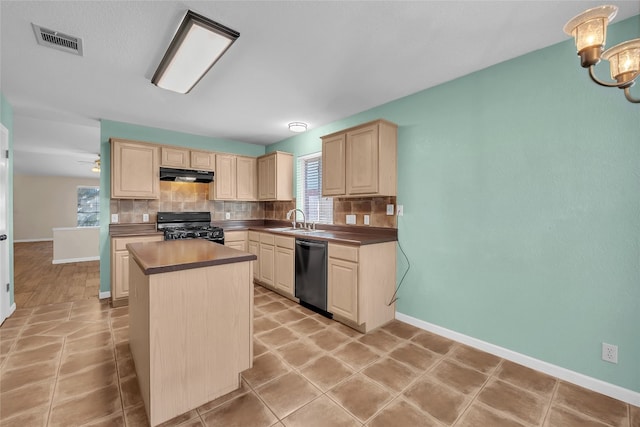 kitchen featuring a center island, backsplash, black appliances, sink, and ceiling fan