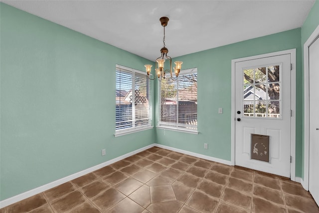 unfurnished dining area with a notable chandelier