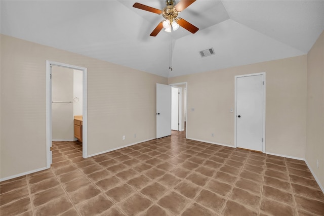 unfurnished bedroom featuring ceiling fan, a closet, lofted ceiling, and ensuite bath