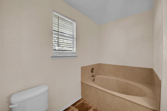 bathroom with tile patterned floors, toilet, and a bathtub