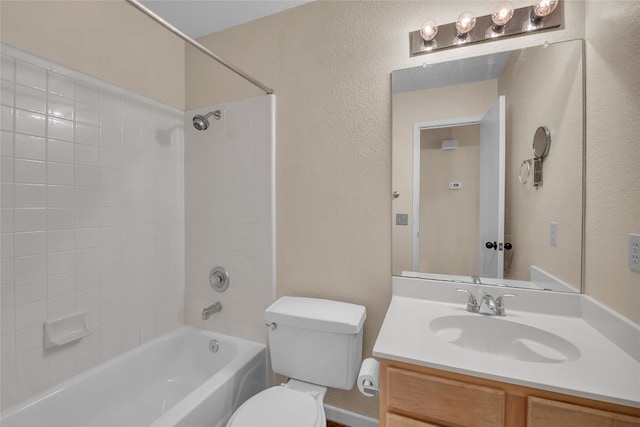 full bathroom with vanity, toilet, and tiled shower / bath