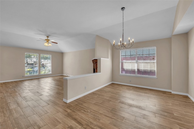 empty room featuring light hardwood / wood-style flooring, a wealth of natural light, and lofted ceiling