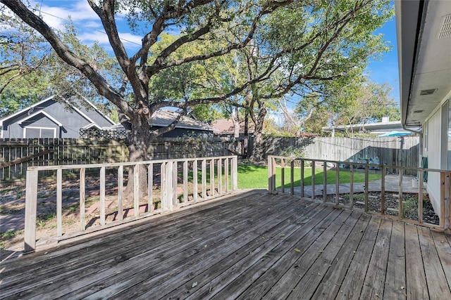 wooden terrace featuring a lawn