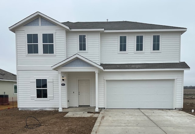 view of front of property with cooling unit and a garage