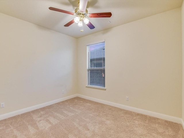 unfurnished room featuring light carpet, ceiling fan, and baseboards