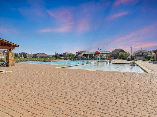 view of swimming pool with a patio area and a residential view