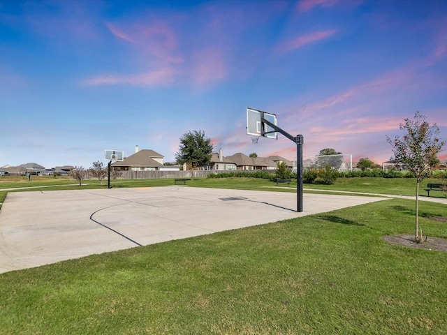 view of basketball court with community basketball court, a lawn, fence, and a residential view