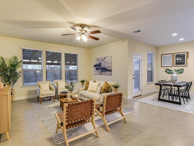 living area with a ceiling fan, recessed lighting, visible vents, and baseboards