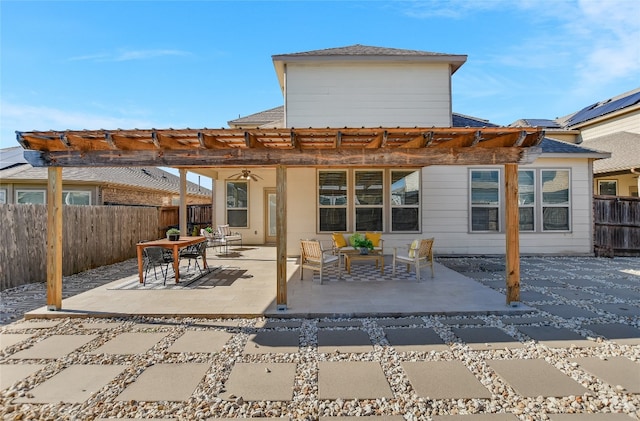 back of house featuring a patio, outdoor lounge area, fence, and a ceiling fan