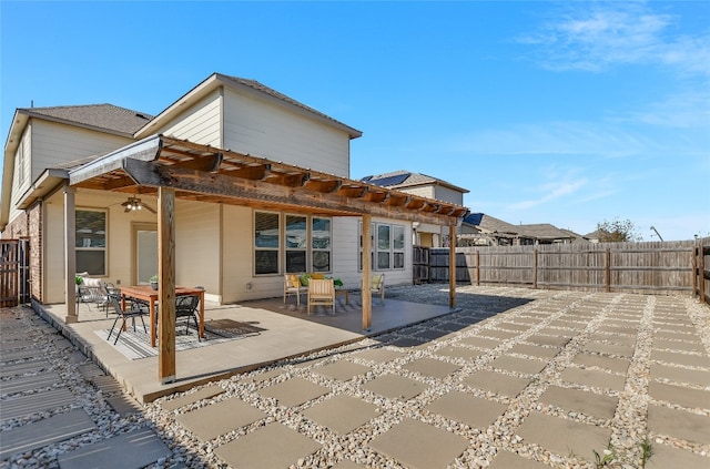 rear view of property featuring ceiling fan, a patio area, and a fenced backyard