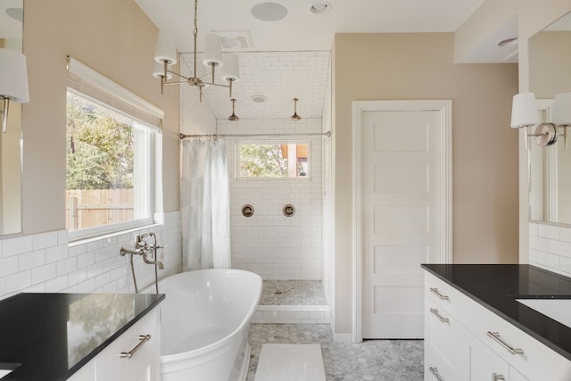 bathroom with tile patterned floors, vanity, shower with separate bathtub, and tile walls