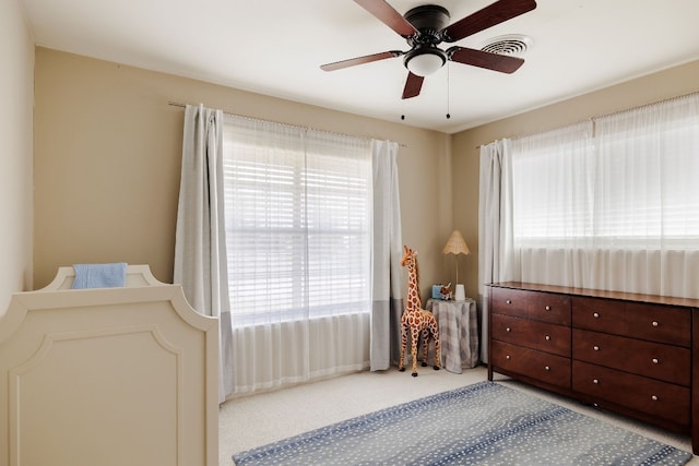 bedroom featuring carpet, multiple windows, and ceiling fan