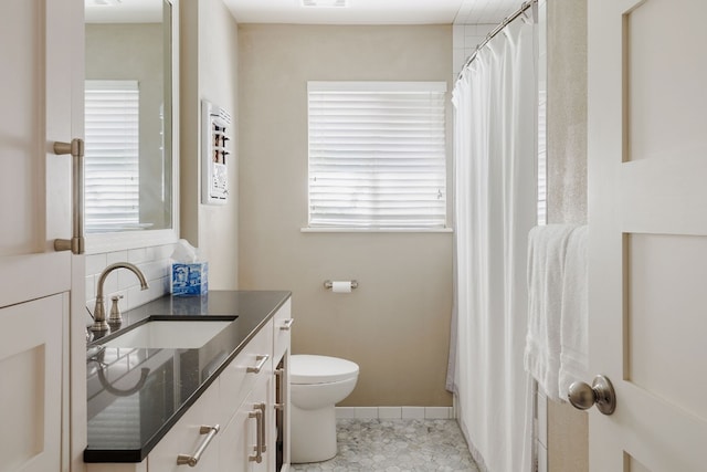 bathroom with tile patterned floors, decorative backsplash, vanity, and toilet