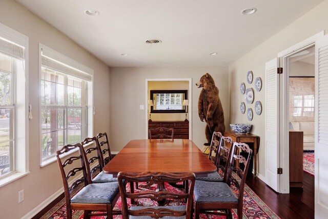 dining area with dark hardwood / wood-style flooring