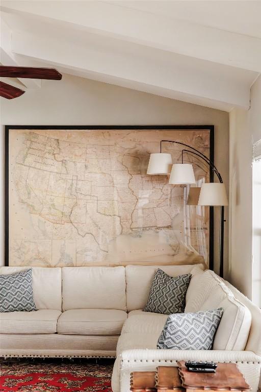 living room with vaulted ceiling with beams