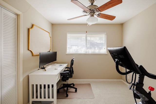 carpeted home office with ceiling fan