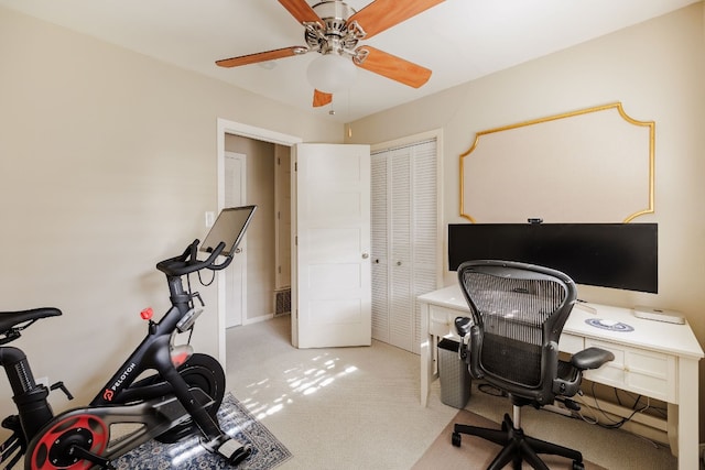 carpeted office featuring ceiling fan