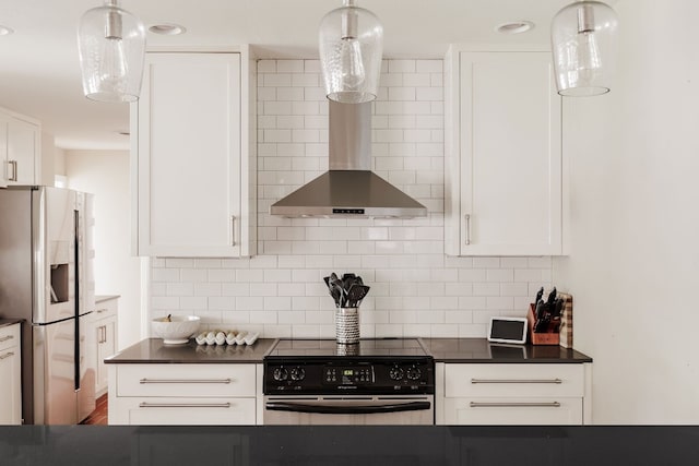 kitchen with appliances with stainless steel finishes, backsplash, wall chimney range hood, decorative light fixtures, and white cabinetry