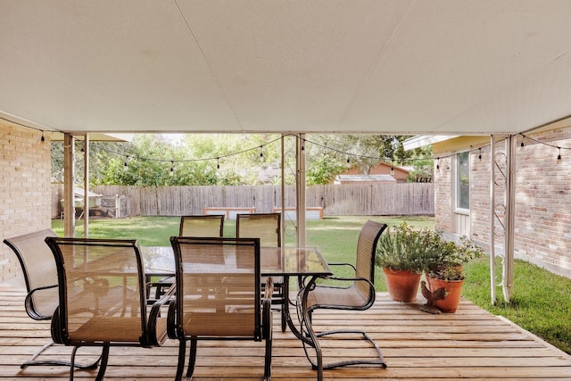 wooden terrace with a yard